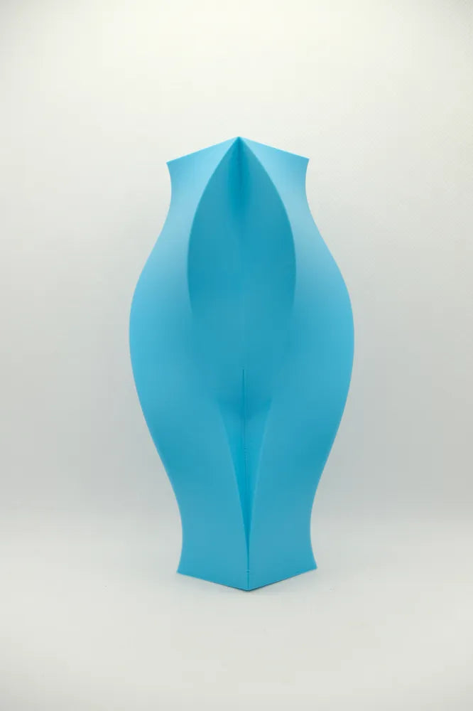 Blue sculptural vase showing its angular geometric facets