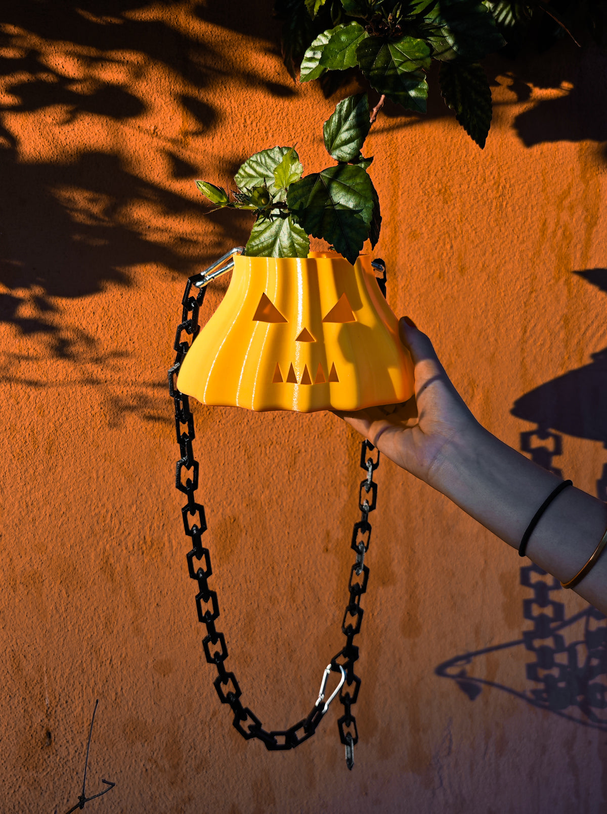 Close lifestyle view of the pumpkin-shaped bag and attached chain links