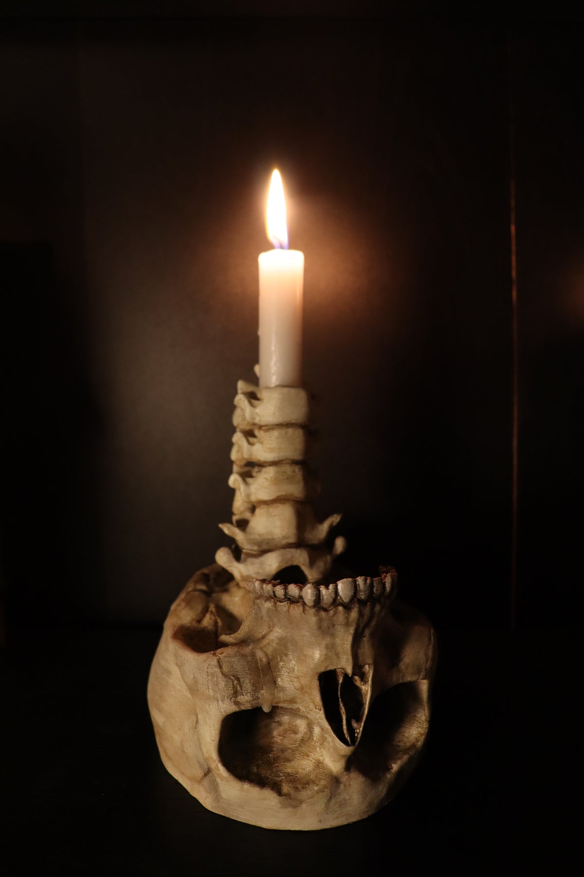 Spine Candle Holder bone white tealight version glowing on dark surface moody editorial