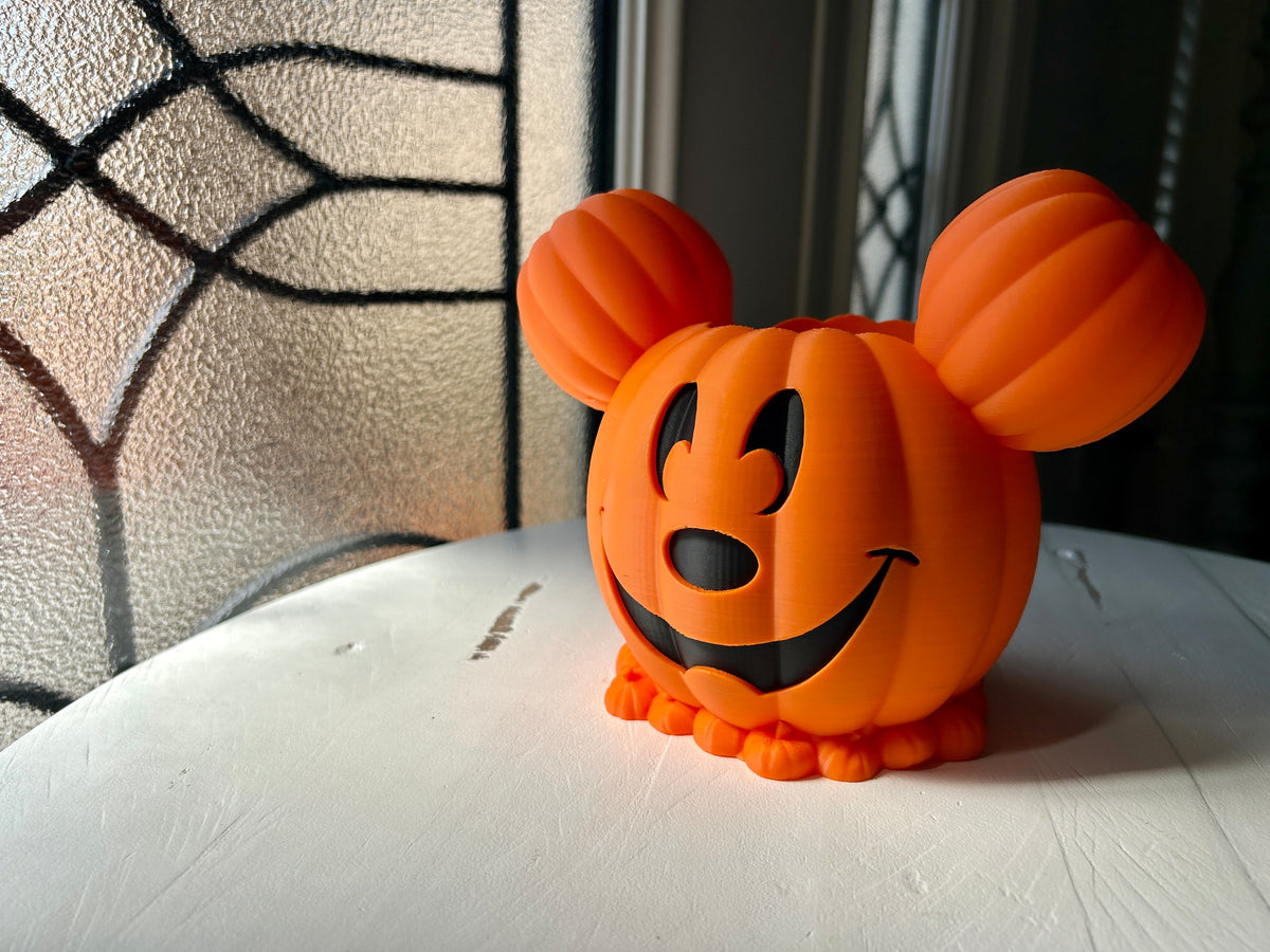 Halloween Pumpkin Soap Dispenser Holder in Orange — three-quarter view without bottle showing full pumpkin sculpt, carved face and decorative base ring