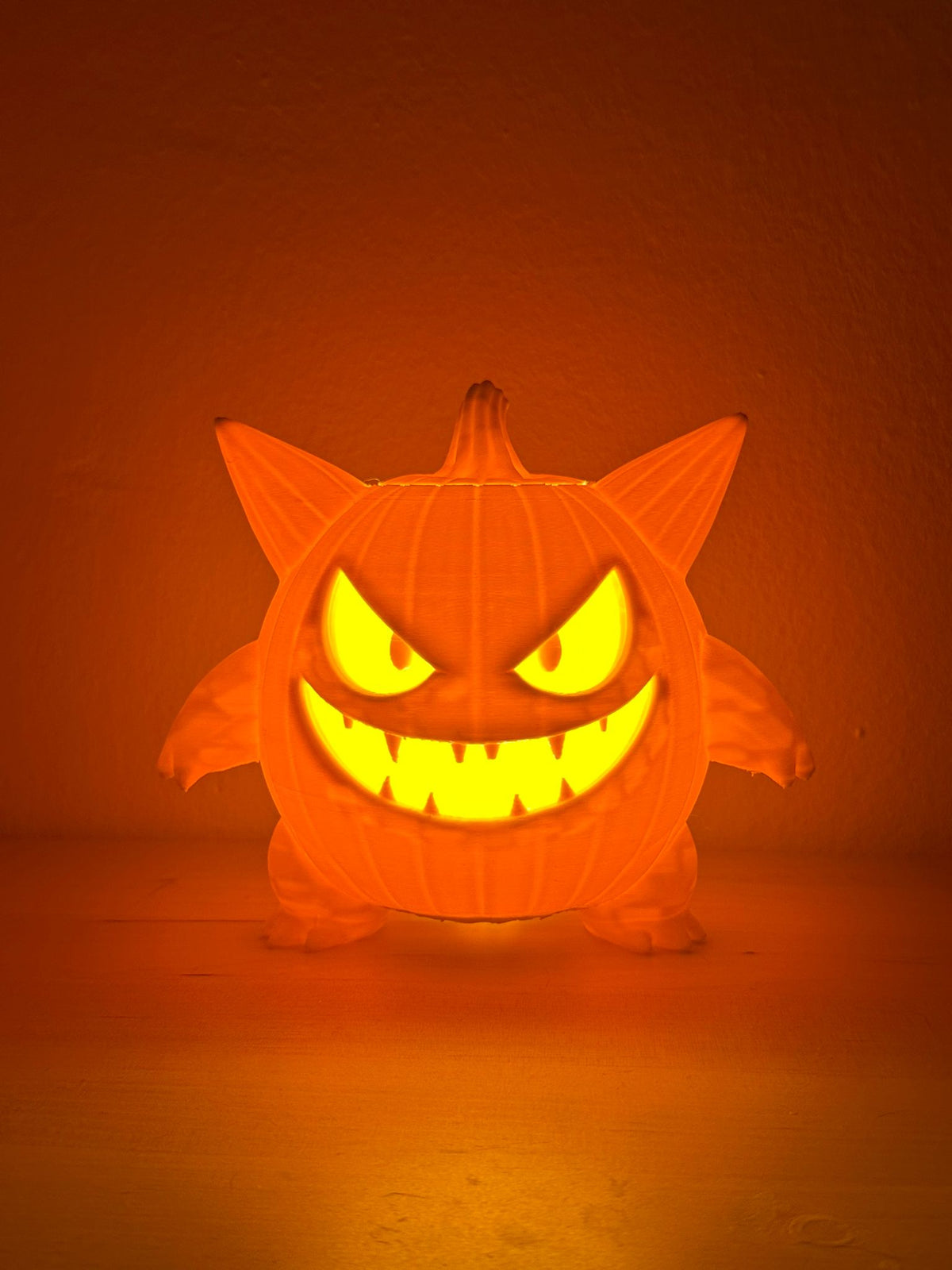 Monster Pumpkin Tealight Holder — large and small sizes together on wood surface showing full character sculpt front view