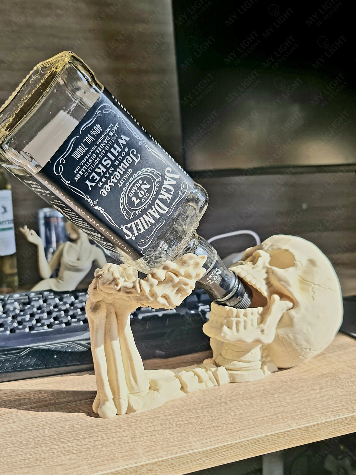 Skeleton Arm and Skull Bottle Holder in bone white — three-quarter front view holding whisky bottle showing skull detail, raised arm and finger grip on wooden shelf
