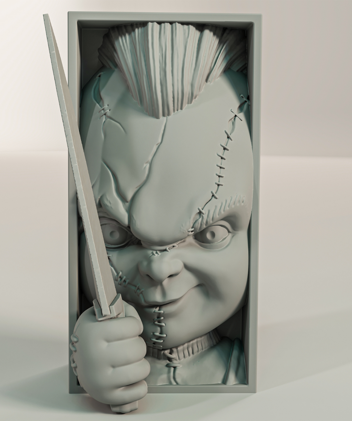Chucky book nook relief sculpture grey matte rectangular framed box rounded doll face deeply scarred slash wounds stitched suture crosses forehead to cheek wild upright mohawk hair menacing wide eyes stubby hand clutching knife blade extending beyond frame three quarter front view neutral background hero product shot
