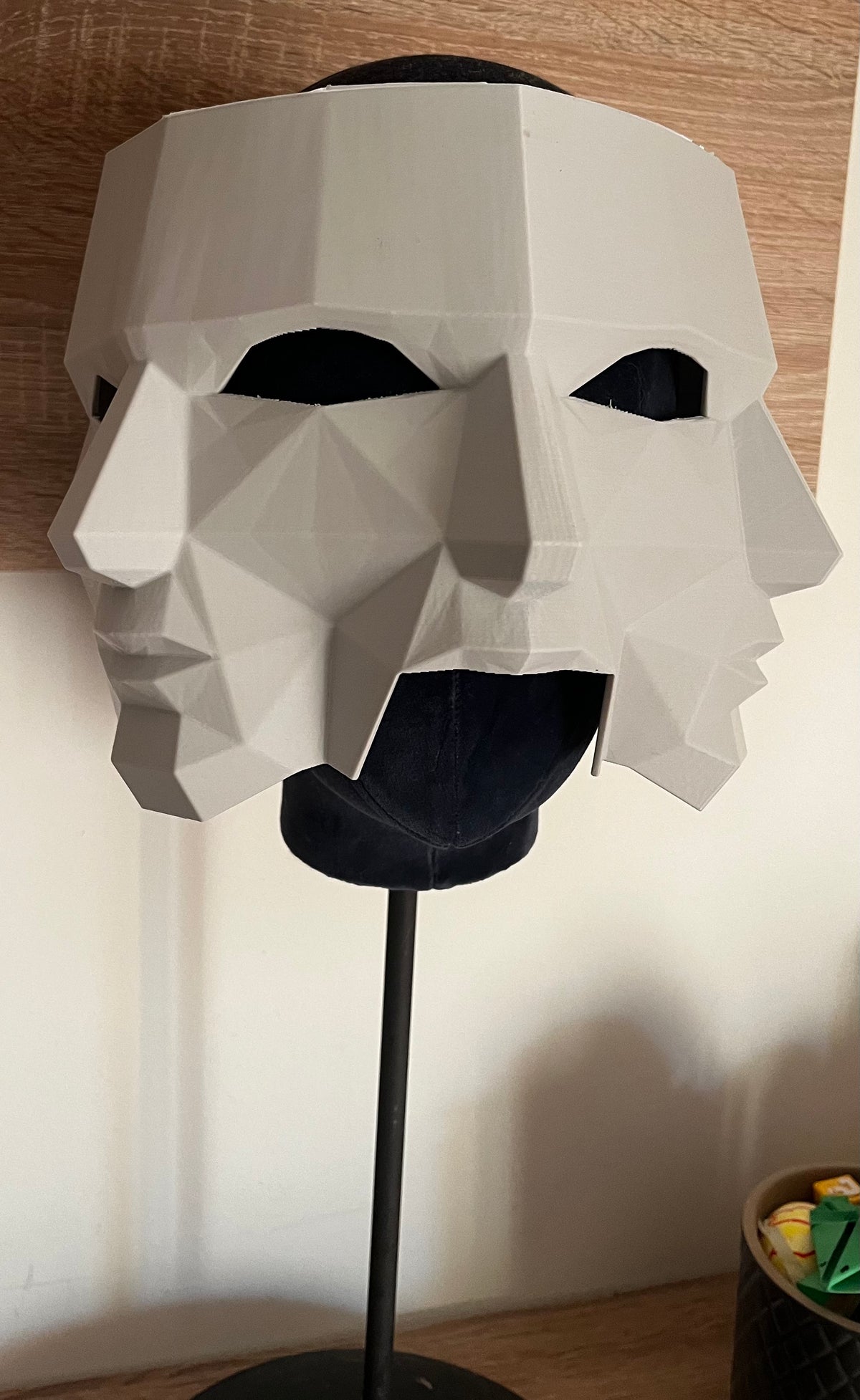 Three Faces of Fear Mask on mannequin head stand — front view