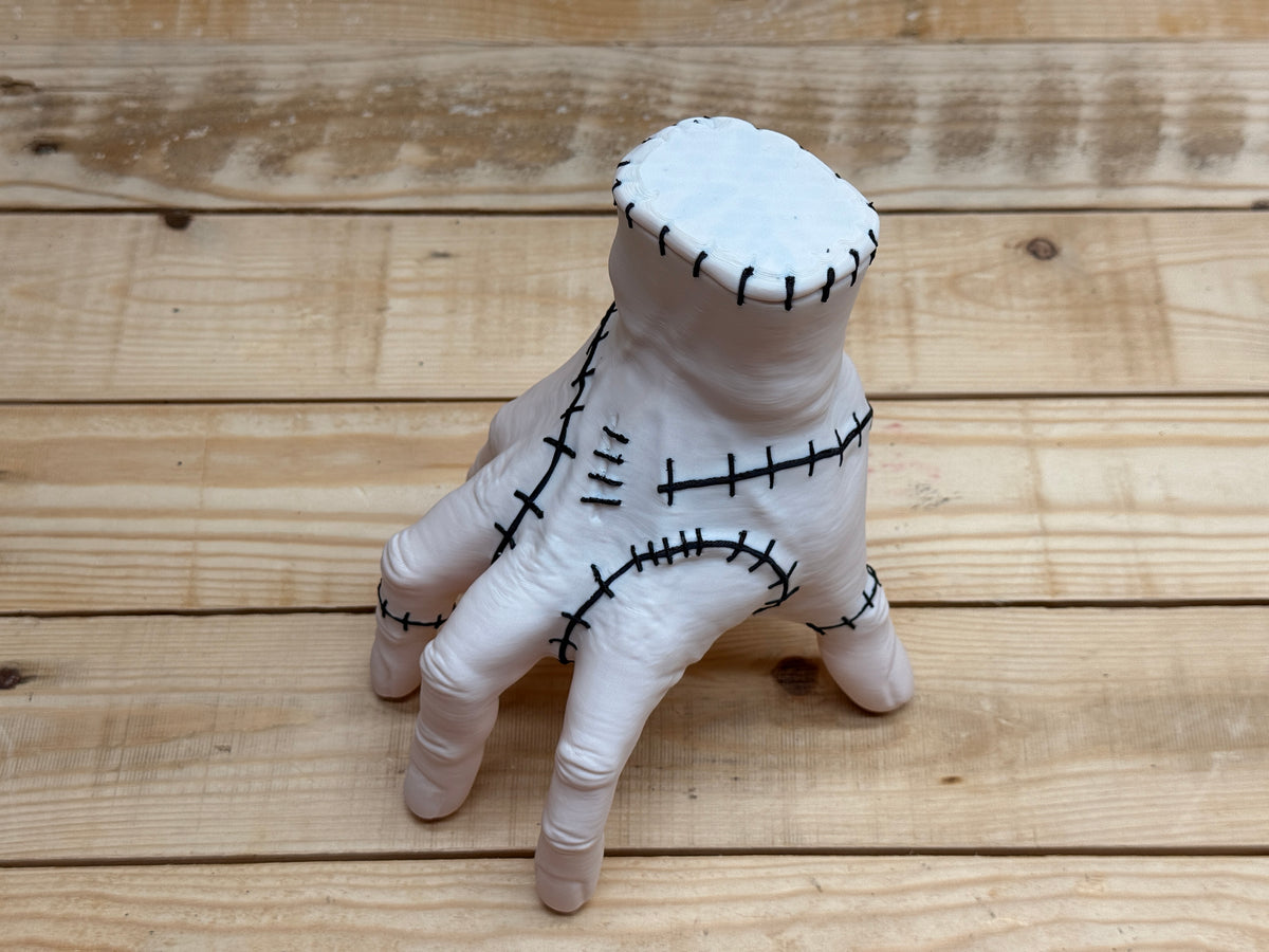 Thing Hand Model — rear three-quarter view standing on fingertips showing wrist seal and back-of-hand stitching detail