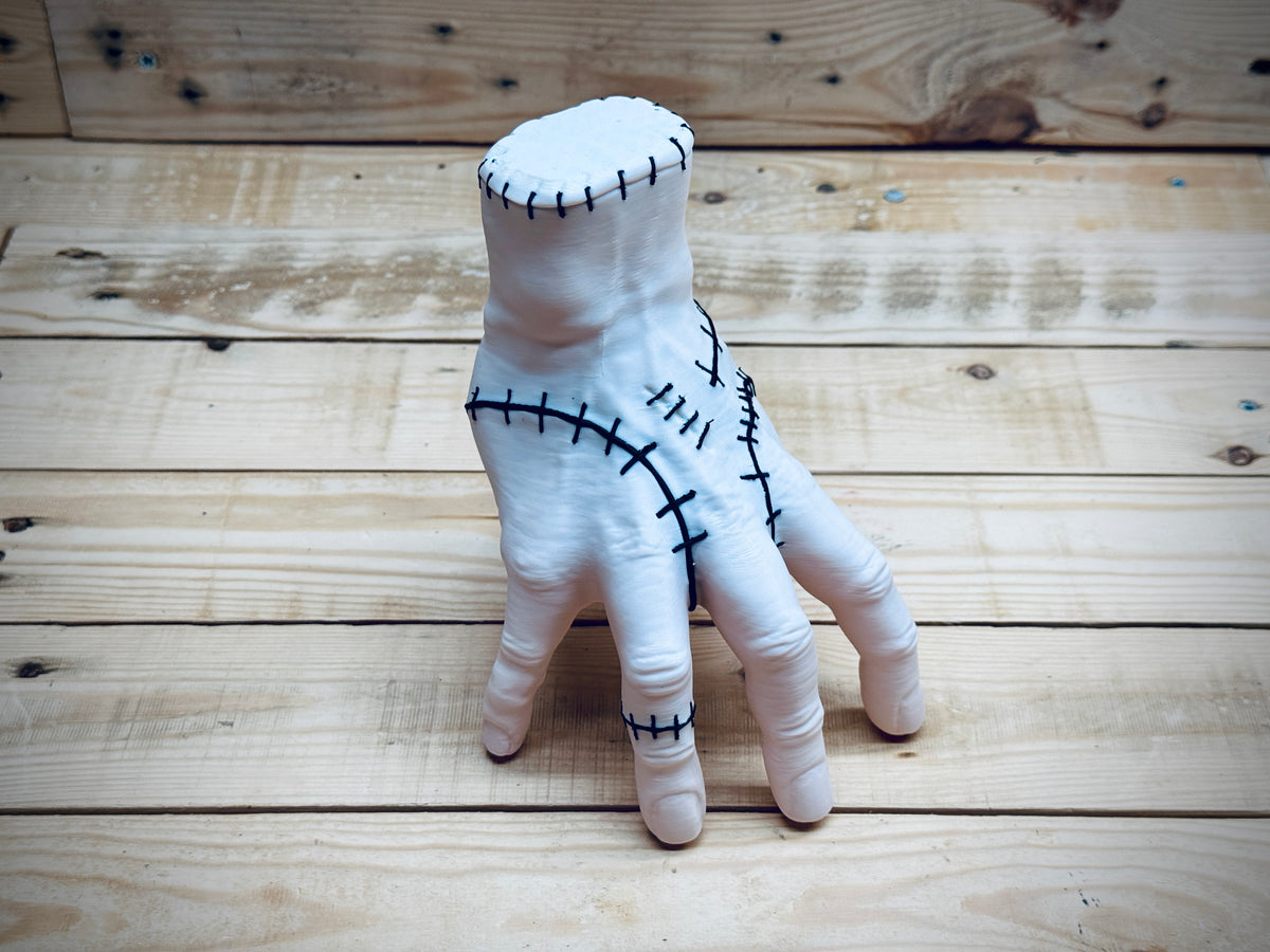 Thing Hand Model — side three-quarter view standing on fingertips showing wrist stitching and overall hand silhouette