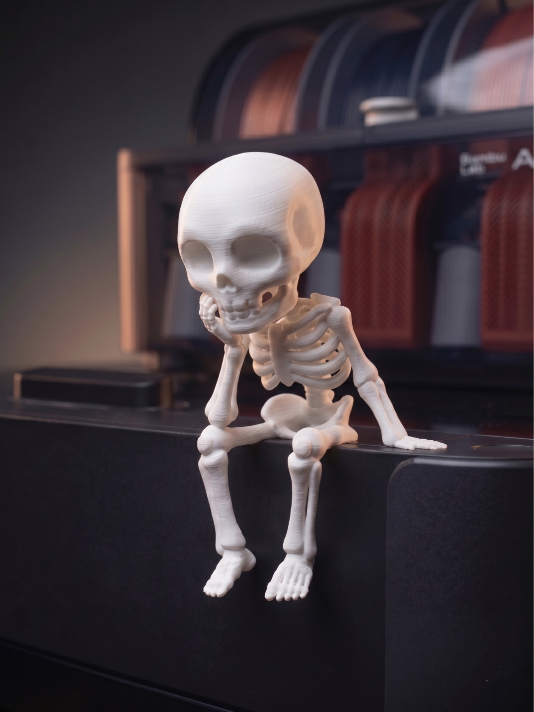 Sitting Sad Skeleton Figure — white skeleton seated on edge of dark surface with legs dangling, chin resting on hand in contemplative pose, dark atmospheric background