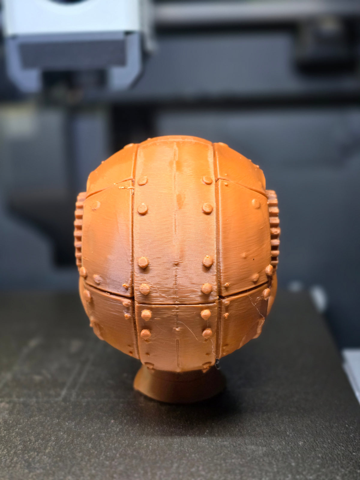 Steampunk Gear Skull Sculpture — rear view showing full riveted steel panel plating across occipital and parietal cranium with raised rivet head rows