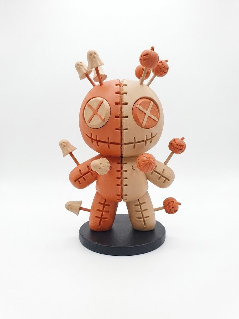 Voodoo Pin Cushion Doll Figure — Plain base edition three-quarter view showing rounded body form, central vertical seam and stitching detail on black circular display stand