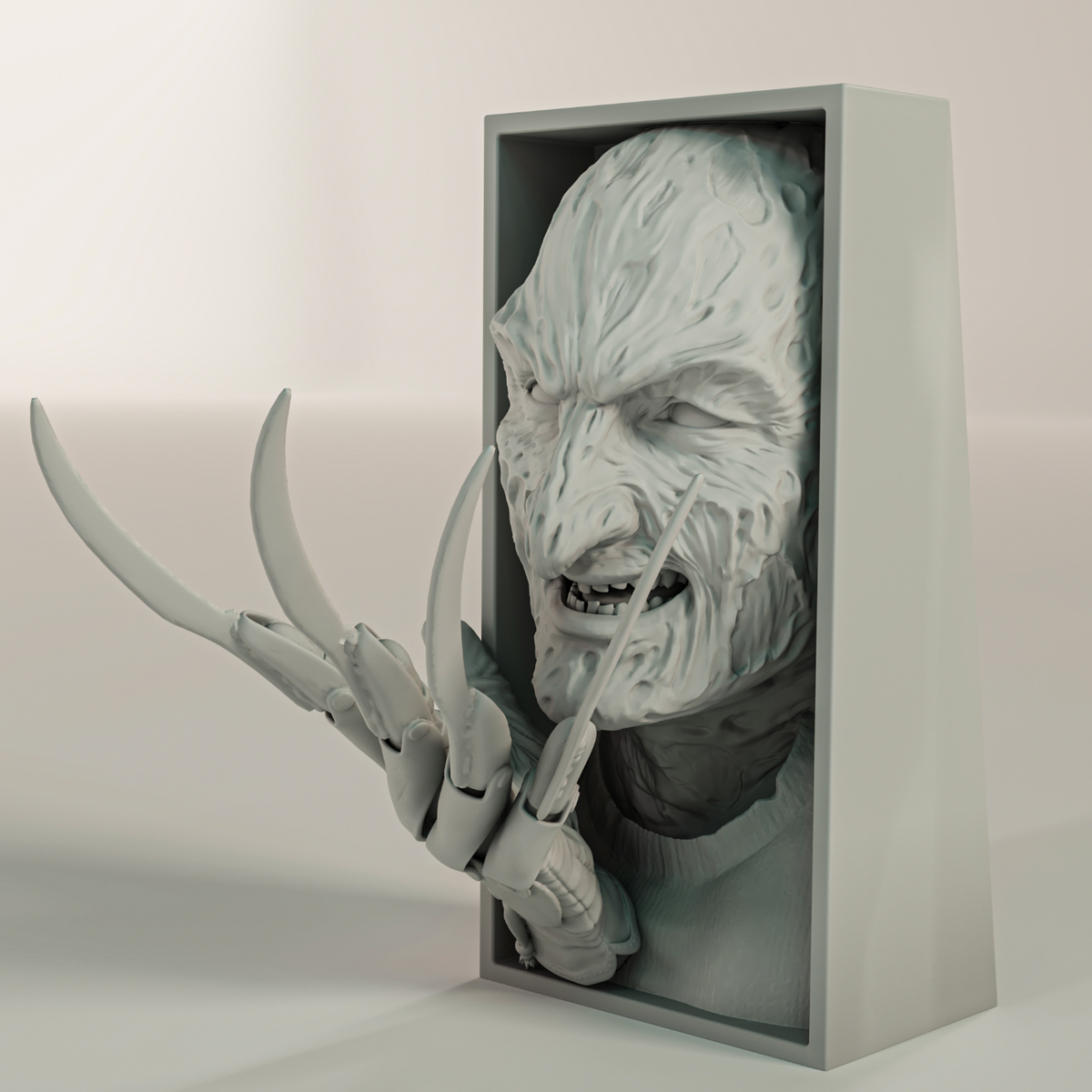 Freddy Krueger book nook relief sculpture grey matte rectangular framed box deeply scarred melted flesh face snarling bared teeth razor claw glove four long curved blades extending dramatically beyond frame three quarter side angle view neutral background showing full three dimensional depth