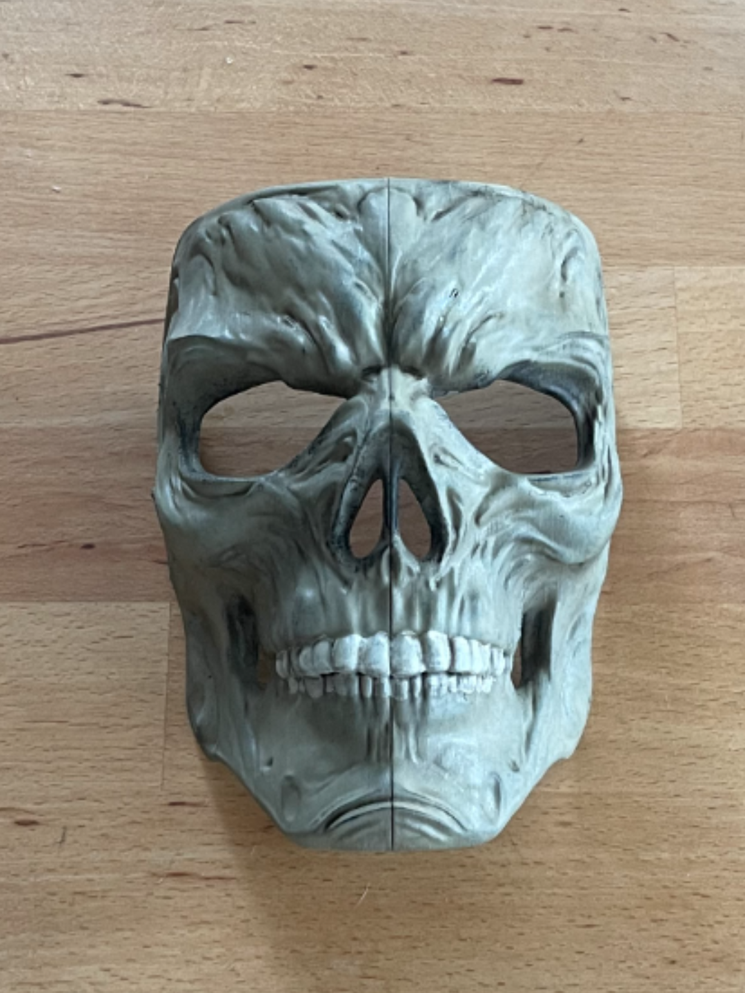 Skull Zombie Mask Sculpture in grey — front view showing full anatomical face coverage with organic cranial surface relief, deep orbital cavities, pronounced supraorbital ridges, nasal aperture, zygomatic arches and complete individual tooth dentition with central sagittal division line