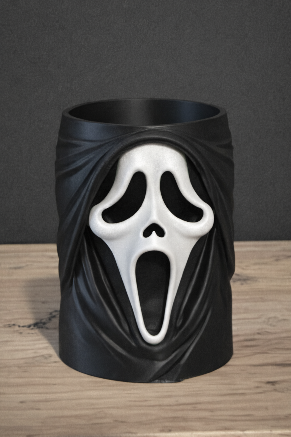 Ghostface Scream Can & Pen Holder — close front view showing full Ghostface mask detail including hollow black oval eye sockets, wide screaming mouth aperture and robe drape relief