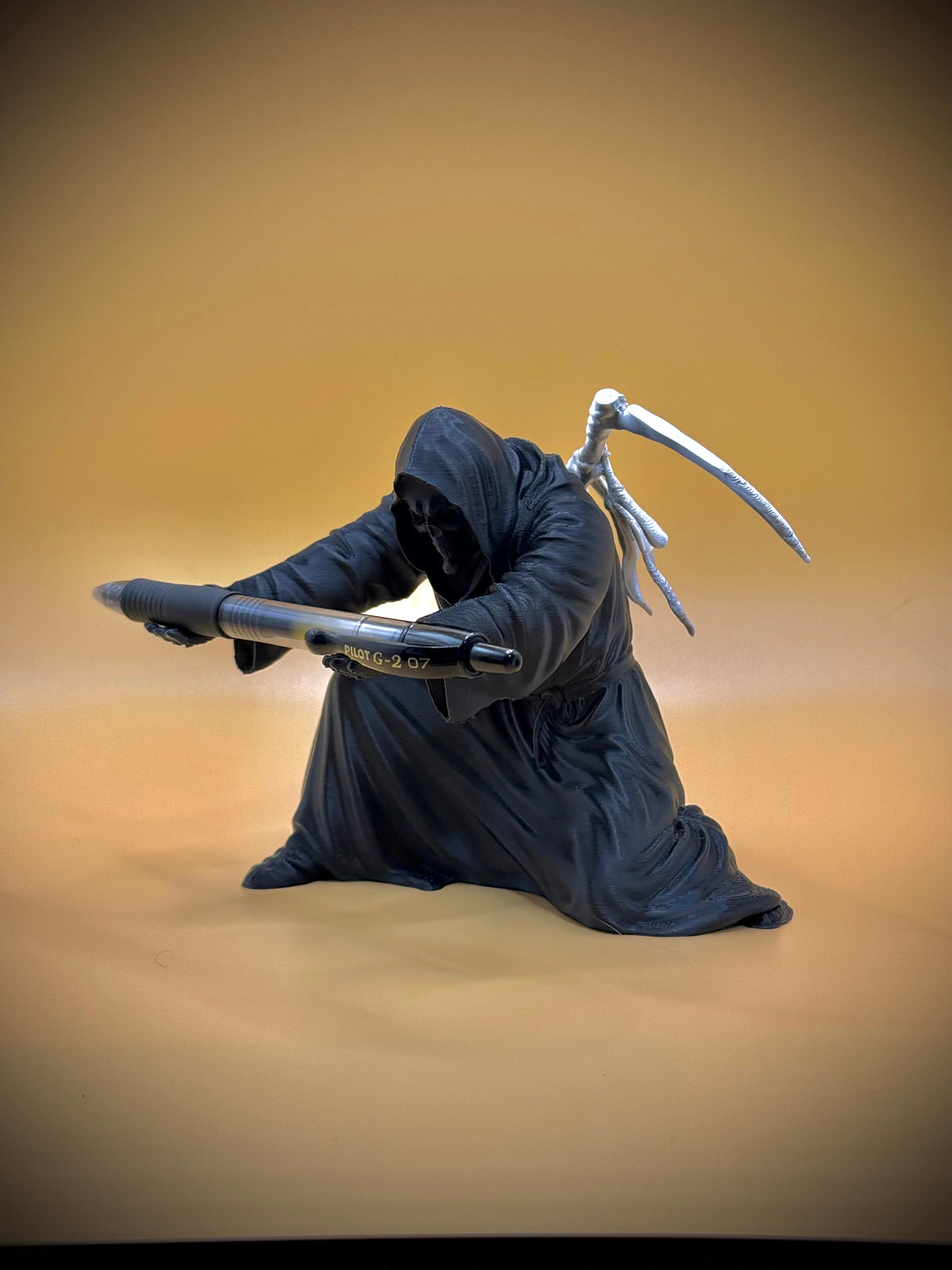 Grim Reaper Pen Holder — side angle on warm background showing full form