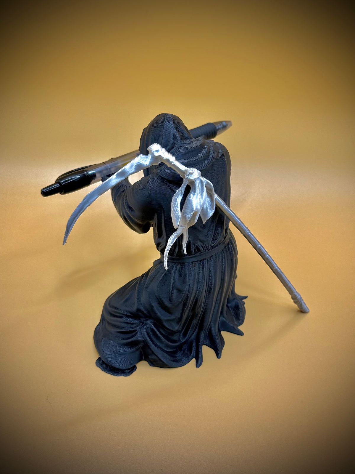 Grim Reaper Pen Holder figurine — rear angle showing robes and skeletal hands gripping pen