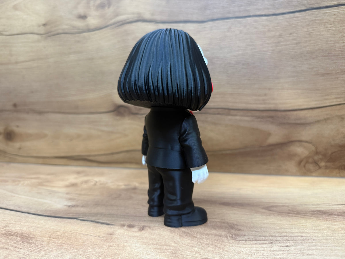 Billy the Puppet Saw Minifigure Sculpture — rear full view showing complete black bob hair mass with individual strand lines from parting, black formal suit back, trouser seam lines and white gloves at sides