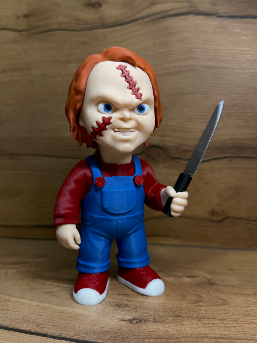 Chucky Child's Play Horror Minifigure — front view: orange-red hair, vivid blue eyes, angry snarl, red zigzag scar with suture stitches, blue dungarees with red button studs, silver serrated knife, dark red trainers with white soles