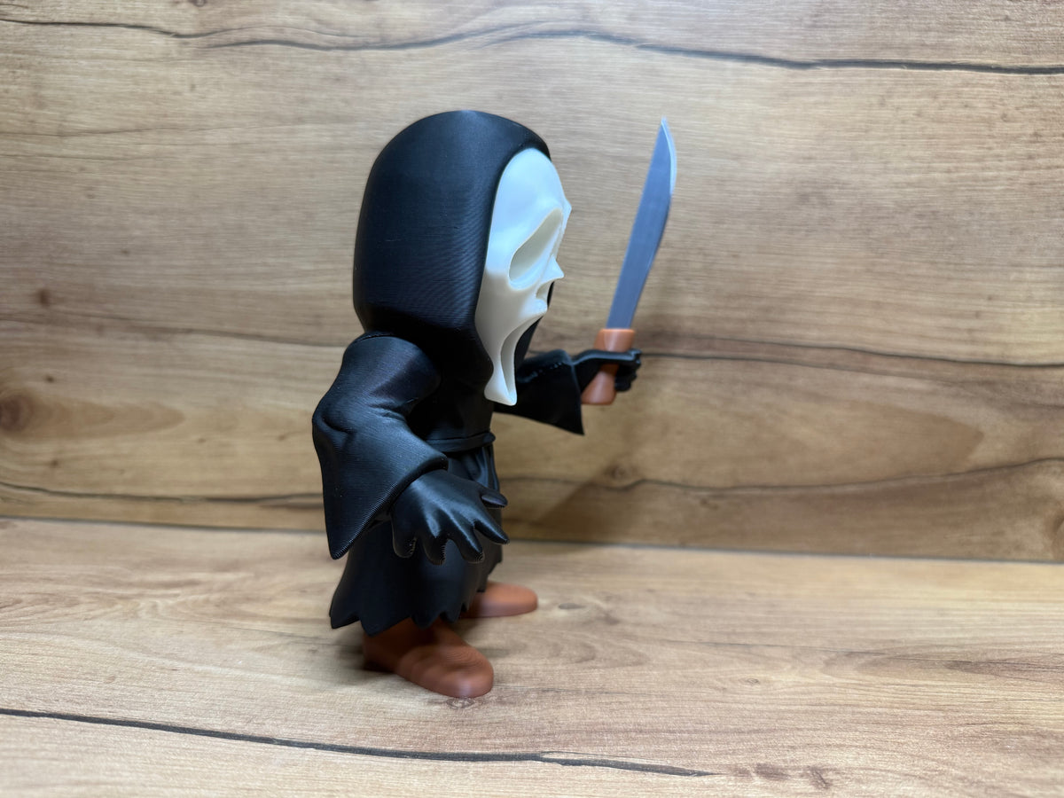 Ghostface Scream Horror Minifigure Sculpture — right side profile classic screaming mask variant: white elongated mask profile showing drooping lower mask point depth, single black teardrop eye aperture visible, black hood dome profile with fabric drape, right arm extended forward holding silver serrated knife at chest height, robe body profile with waist cord and zigzag hem, warm tone boots below robe hem