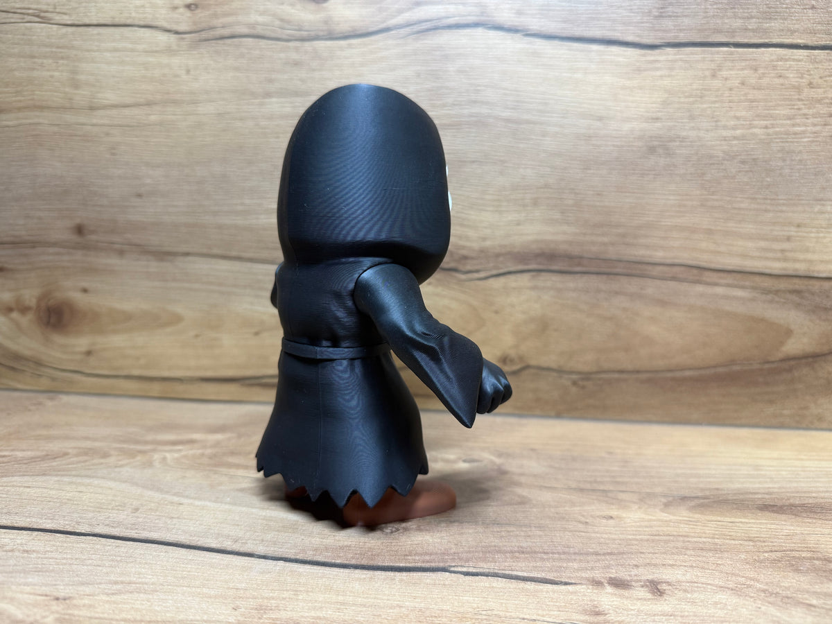 Ghostface Scream Horror Minifigure Sculpture — rear full view: smooth black hooded dome from rear, full robe rear panel with natural drape lines, waist cord tie visible at rear, right arm extended holding silver knife visible from rear angle, zigzag robe hem from rear and warm tone boots below