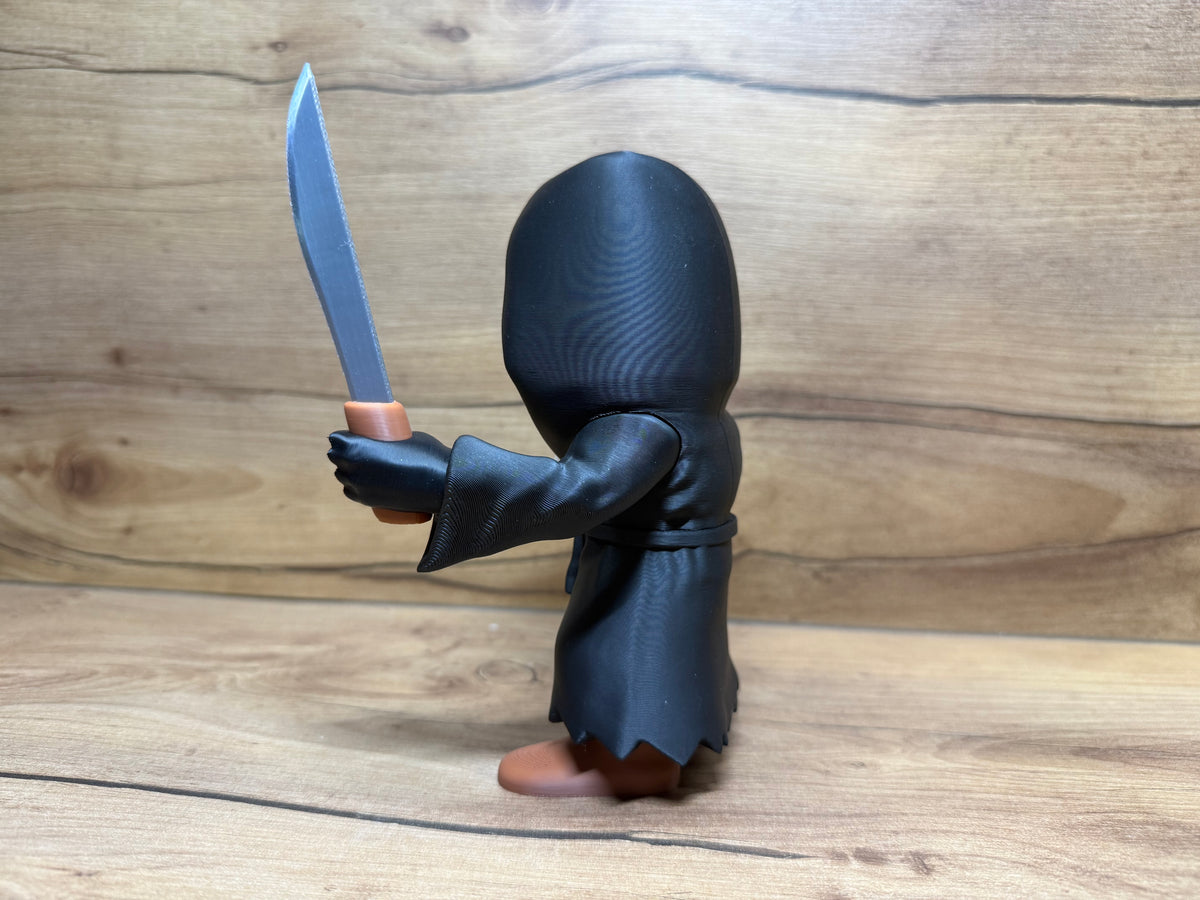 Ghostface Scream Horror Minifigure Sculpture — left rear three-quarter view: black hood dome at angle showing mask face partially visible from left rear, left arm visible at side, robe body rear panel and waist cord, right arm extended forward with silver serrated knife raised, zigzag robe hem and boot tops from rear three-quarter angle