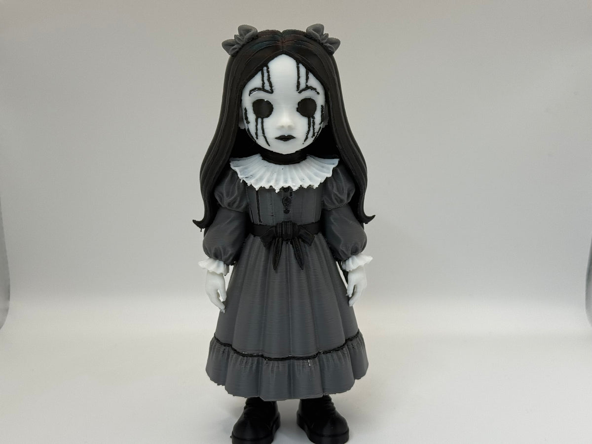 Gothic Doll Horror Minifigure Sculpture — front three-quarter view variant A showing full figure in neutral standing pose — cracked white mask with drip lines, horn bow ornaments, black hair fall, white ruffled collar, grey Victorian dress with waist bow and tiered skirt, white hands at sides and black shoes