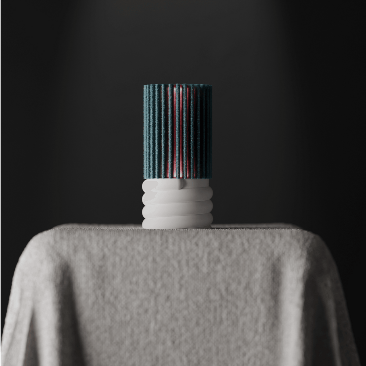 Ribbed Cylindrical Desk Lamp teal ribbed cylinder and white spiral base on linen-draped plinth dark background fine art editorial