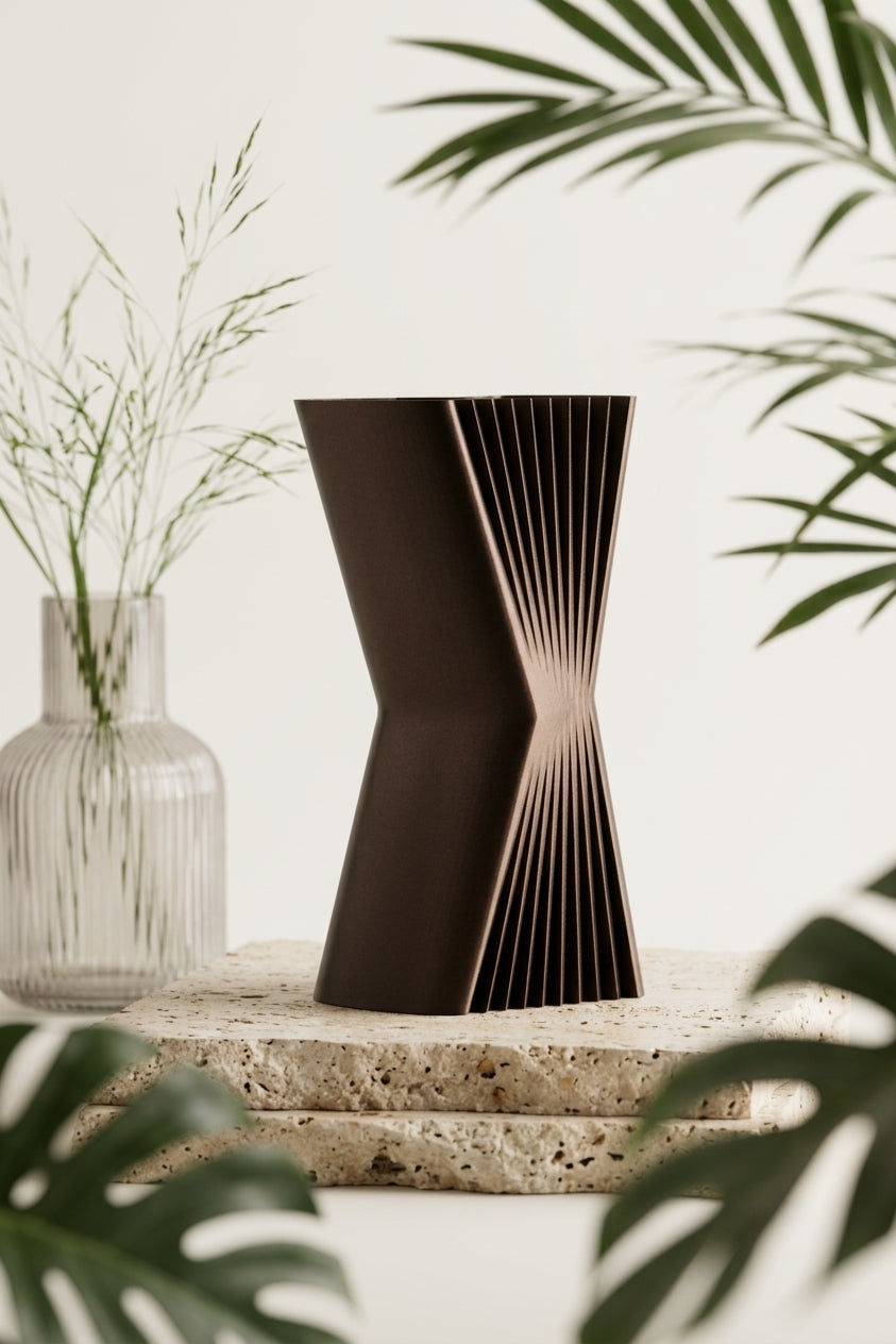 Elegant Angular Decorative Vase dark brown on black stone plinth dark monstera gold vase editorial