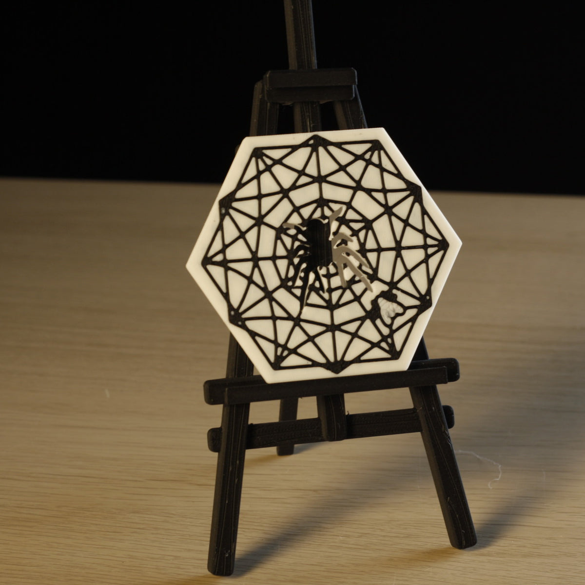 Close-up of hexagonal Spider Web Coaster with spider