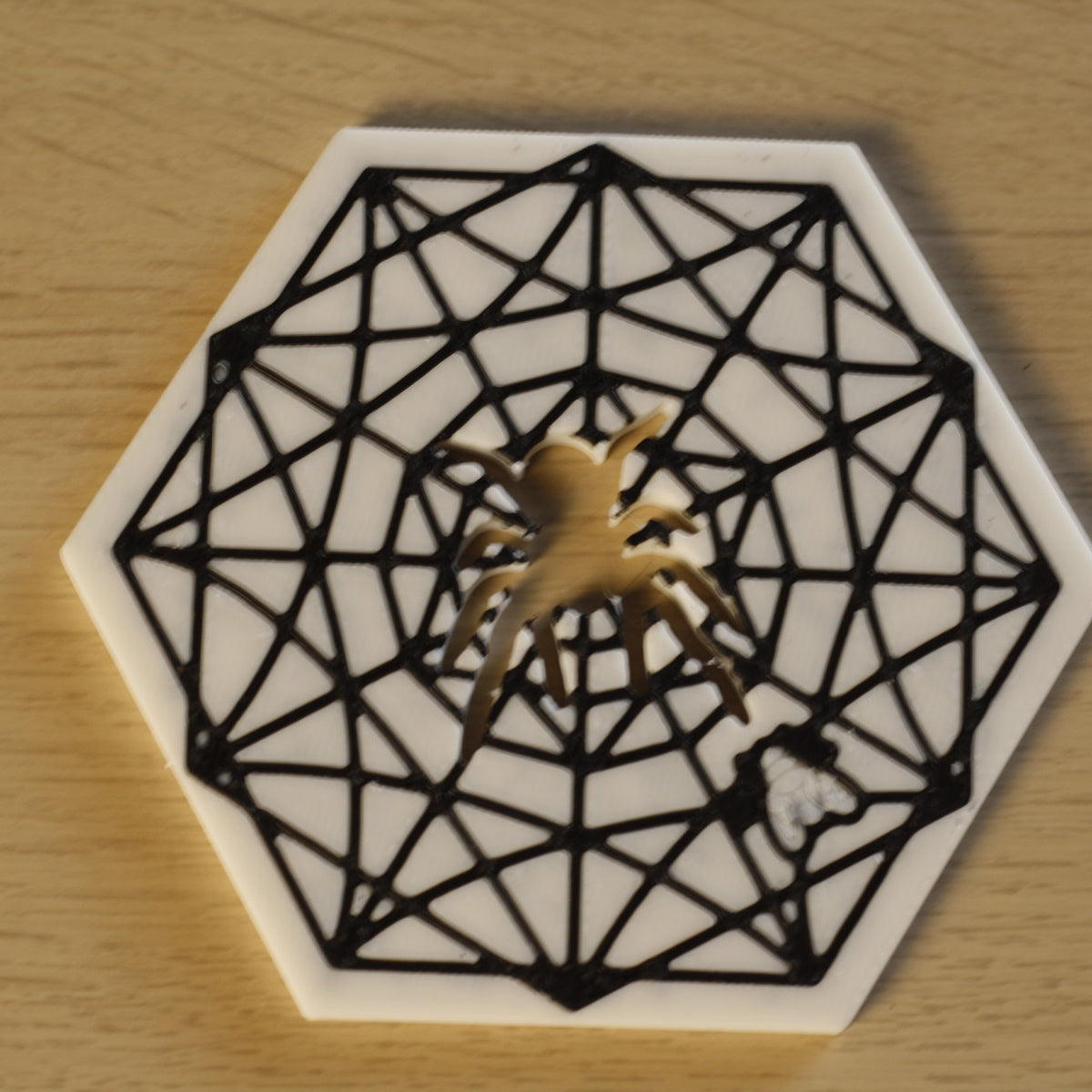 Spider Web Coaster displayed on small stand