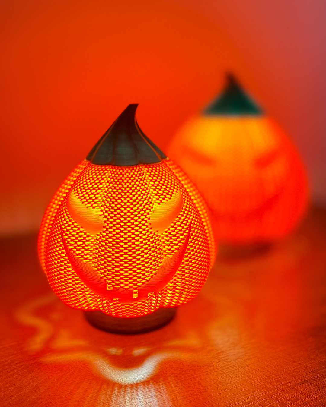 Orange mesh-look Evil Pumpkin decoration with a dark pointed stem and wicked face