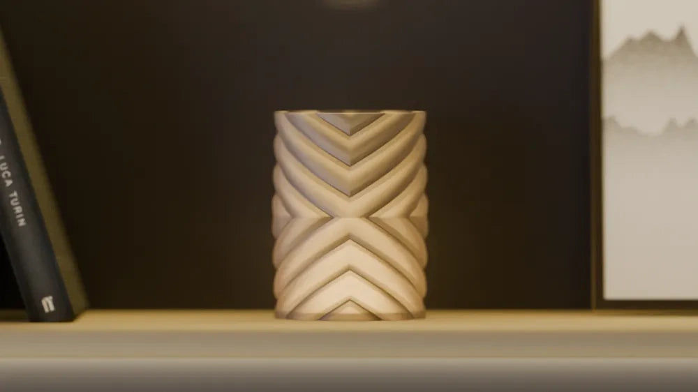 Cream geometric lampshade with angular chevron pattern on a dark bookshelf