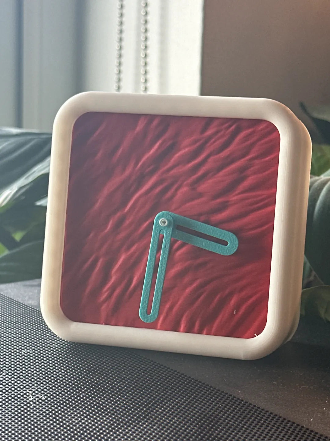 Modern Minimalist Textured Desk Clock Black frame with Green ripple texture face surrounded by pastel geometric shapes grey background
