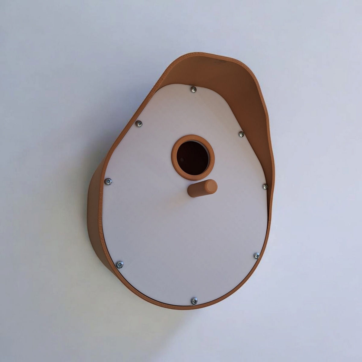 Bird Home modern curved birdhouse with tan roof mounted on weathered white wooden fence