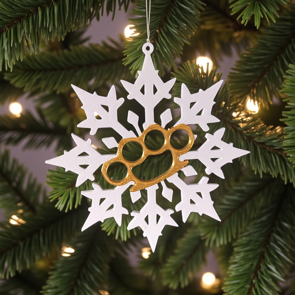 Bad Snowflake ornaments hanging on Christmas tree beside window with winter light