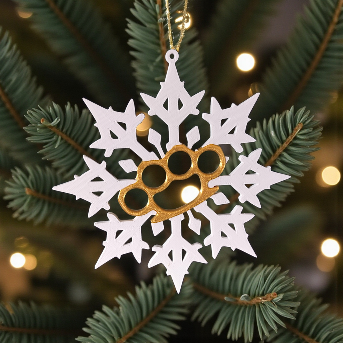 White and gold Bad Snowflake ornaments hanging on Christmas tree with fairy lights