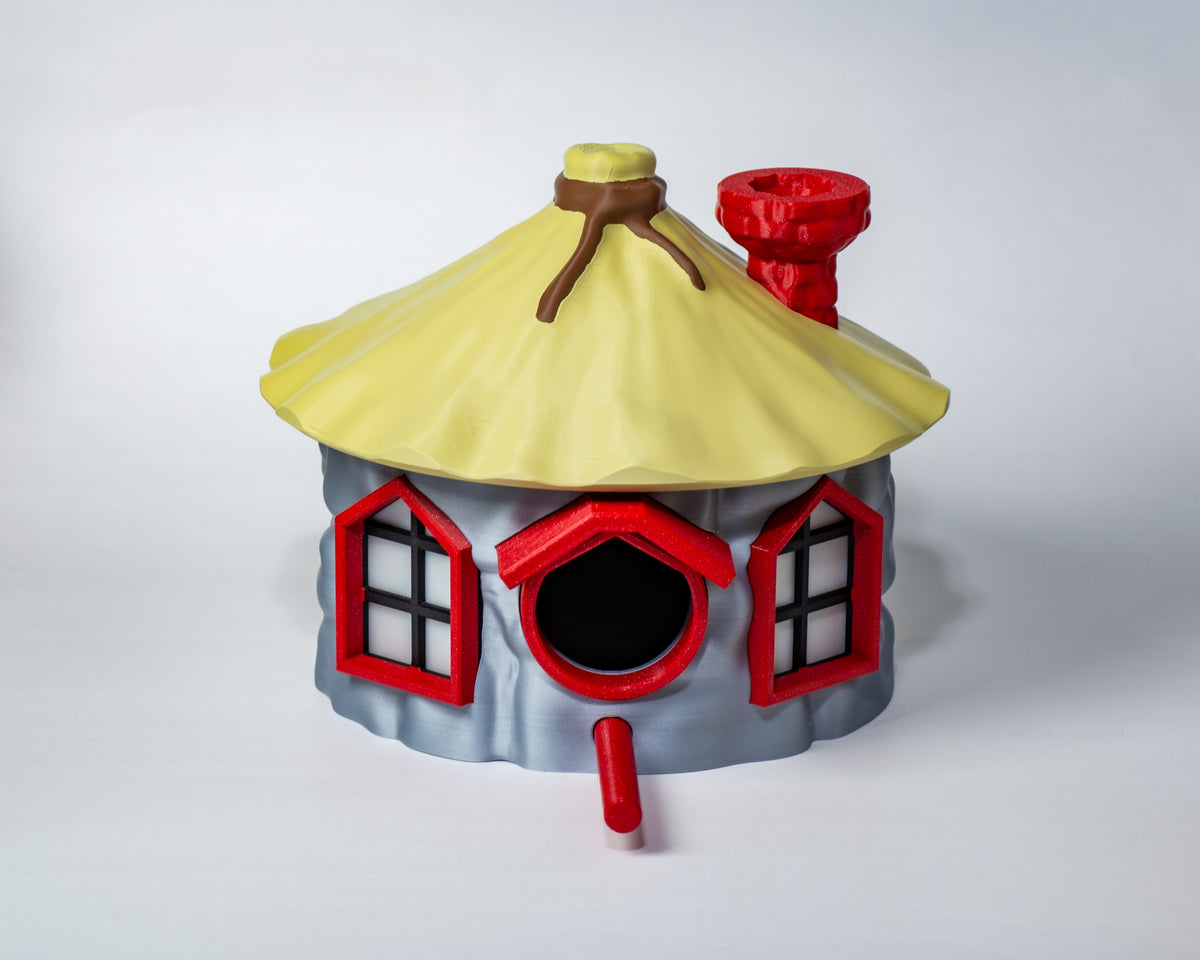 Angled close view of yellow roof, chimney and round birdhouse opening