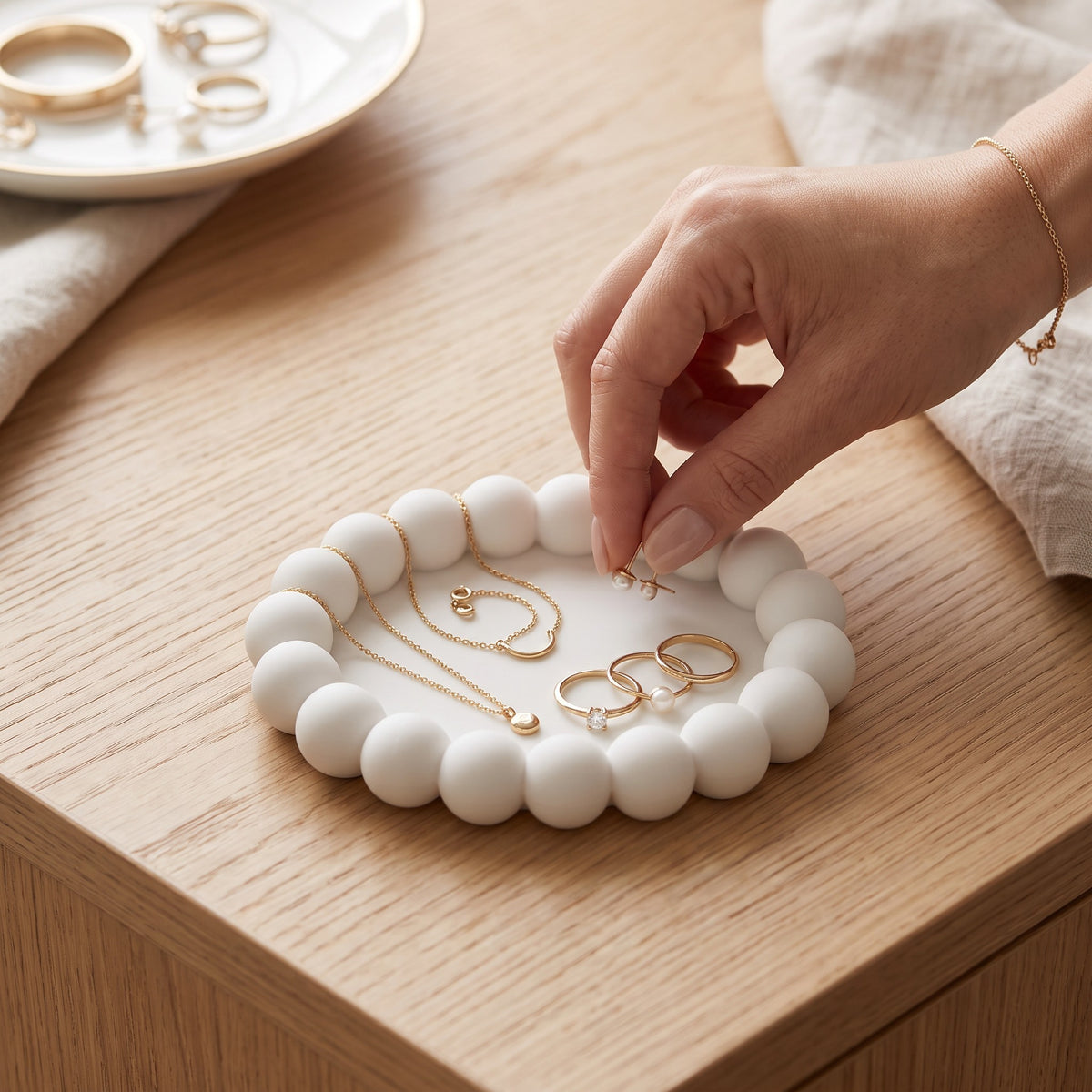 Three white bubble trays on a marble dressing table with a jewellery box and perfume