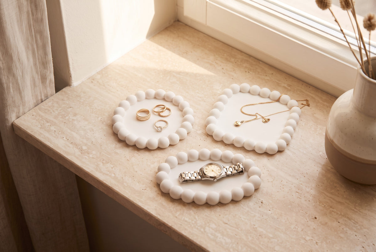 Three white bubble trays on a marble dressing table with a jewellery box