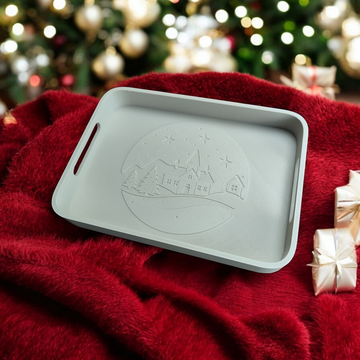Winter village tray on bed of green pine tree branches overhead shot