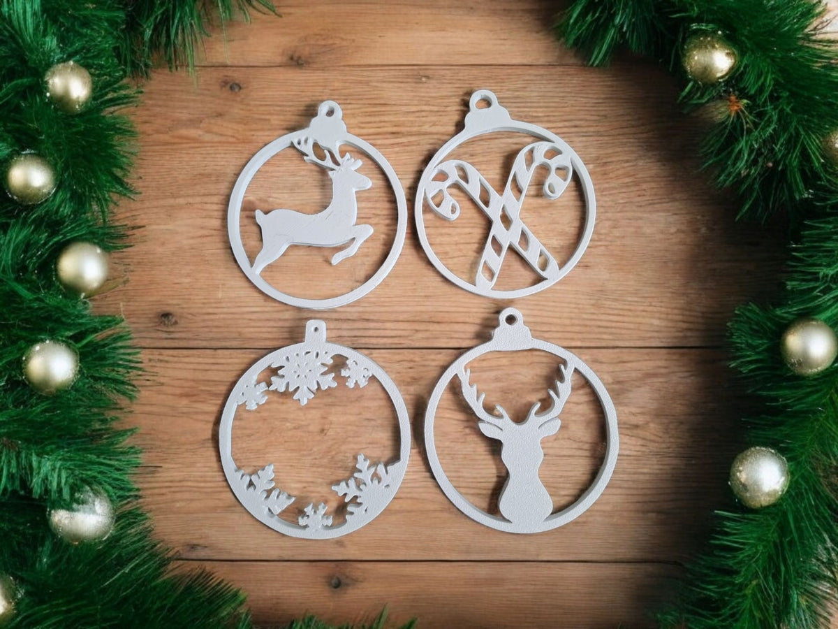 White plastic filigree Christmas ornament hanger set hanging on snowy outdoor Christmas tree warm golden fairy lights bokeh close up atmospheric cosy festive outdoor snow scene portrait
