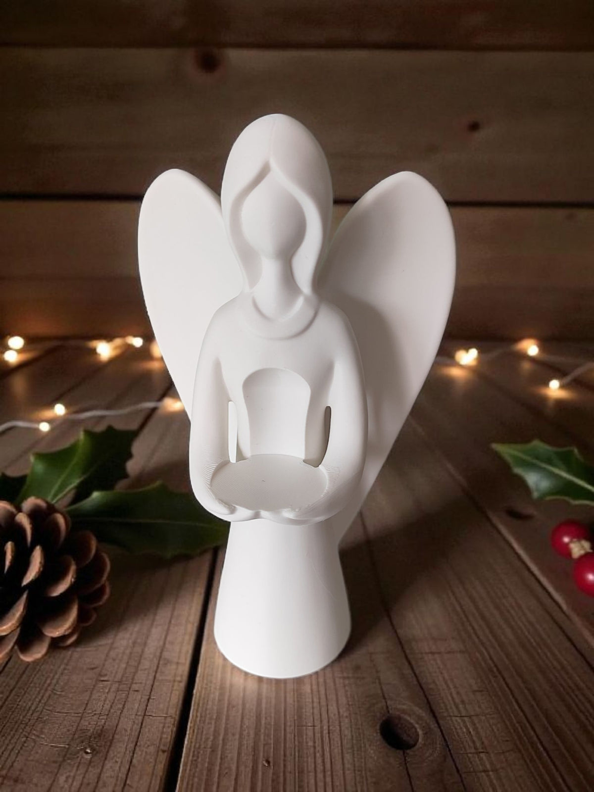 Front angled view of white angel on wooden table warm natural light