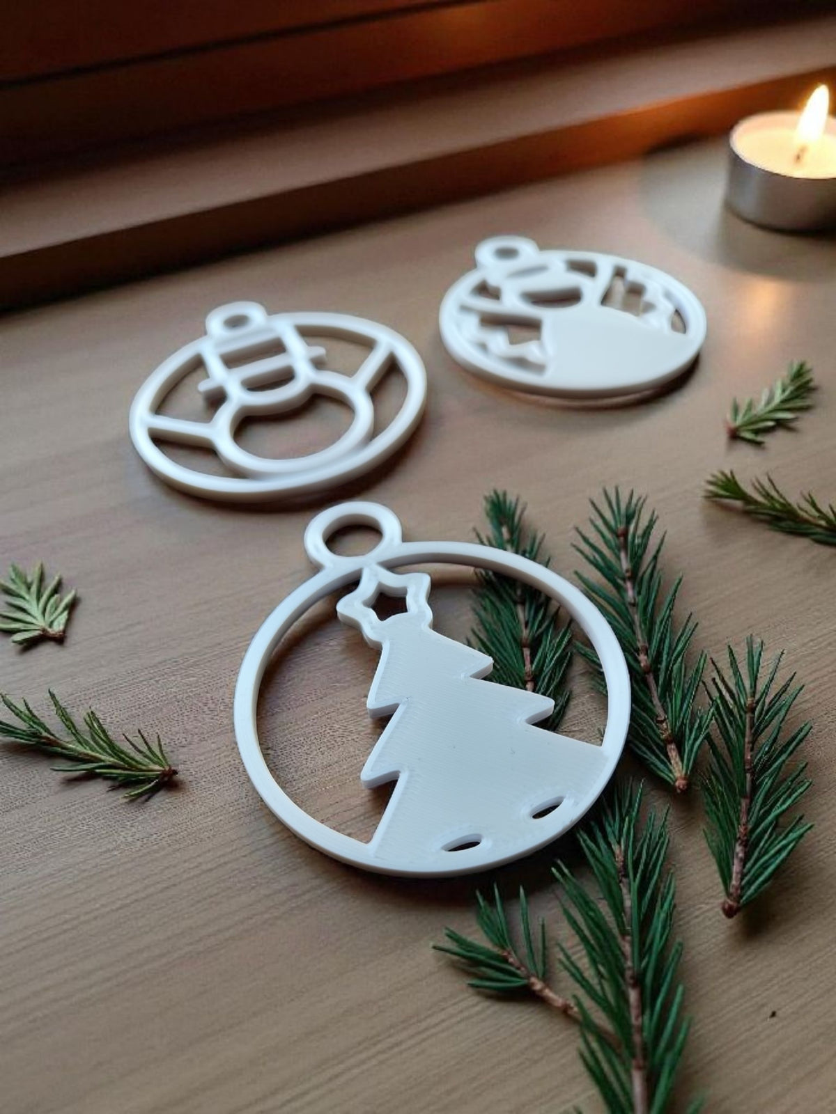 Full set of eight Christmas ornaments in gold and silver on dark wooden decking
