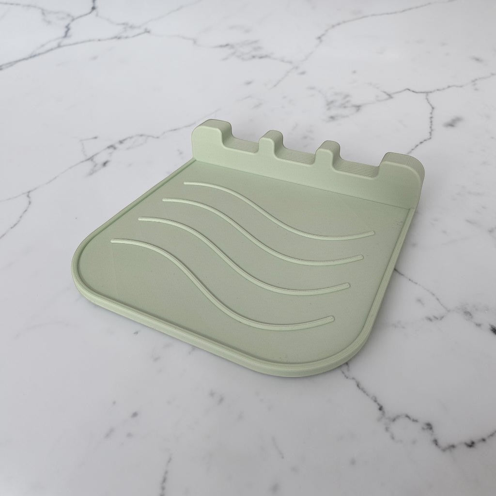 CookSitter utensil rest with three spoons in kitchen