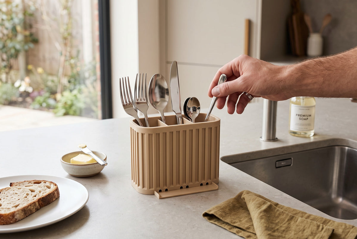 Japandi Cutlery Drainer beige beside black sink woman placing knife editorial