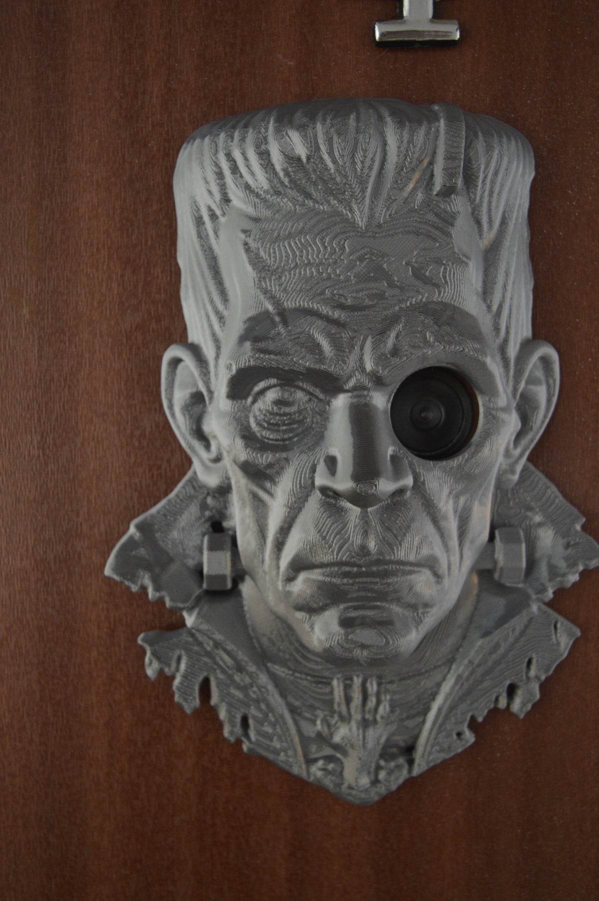 Close-up of Frankenstein decoration eye surrounding door peephole