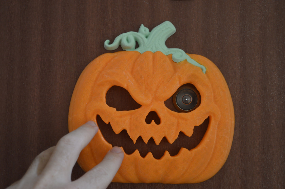 Close-up of existing door viewer framed by pumpkin eye