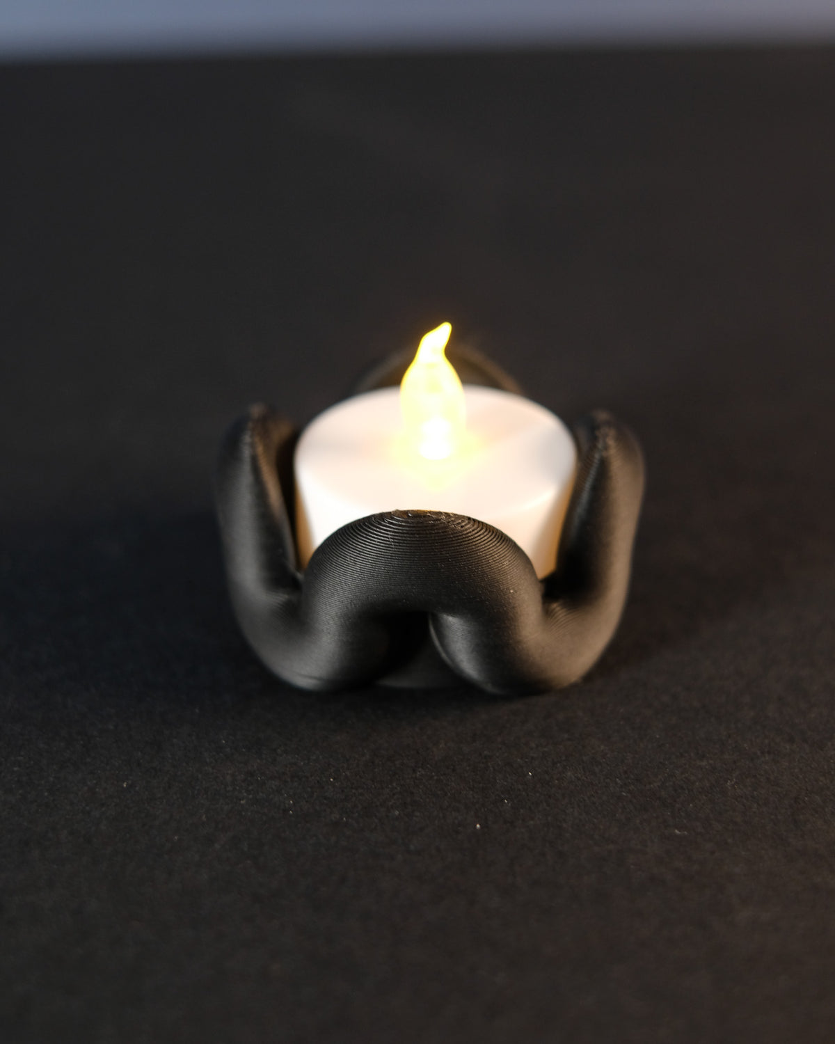 Wibble Tealight Holder - three pastel versions in a row on white surface