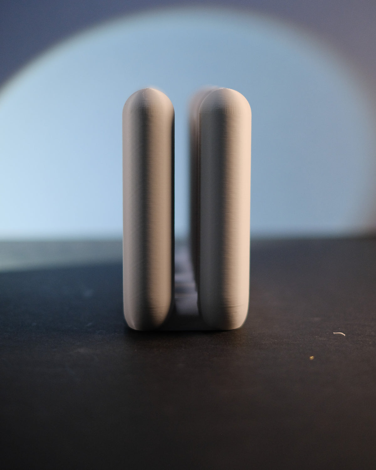 Wibble Vertical Laptop Stand - real photo angled view beige on dark surface