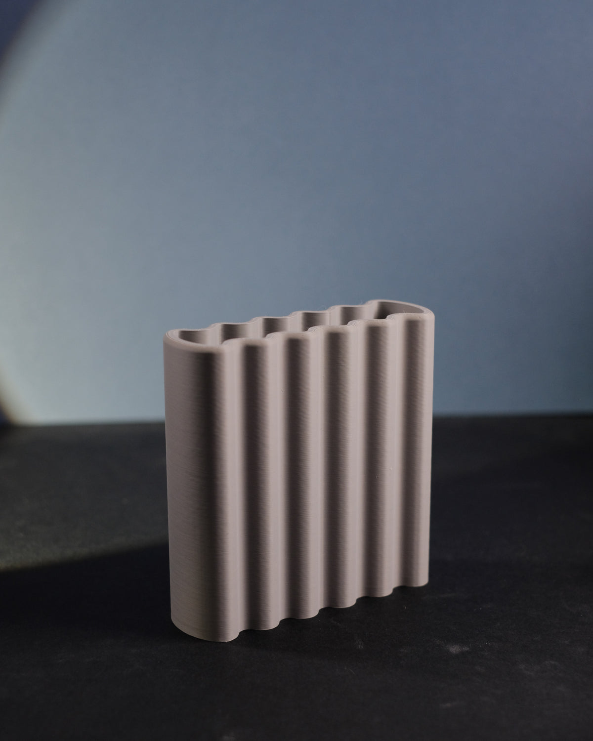 Terracotta orange ripple toothbrush holder on oak bathroom shelf with succulent and art print lifestyle
