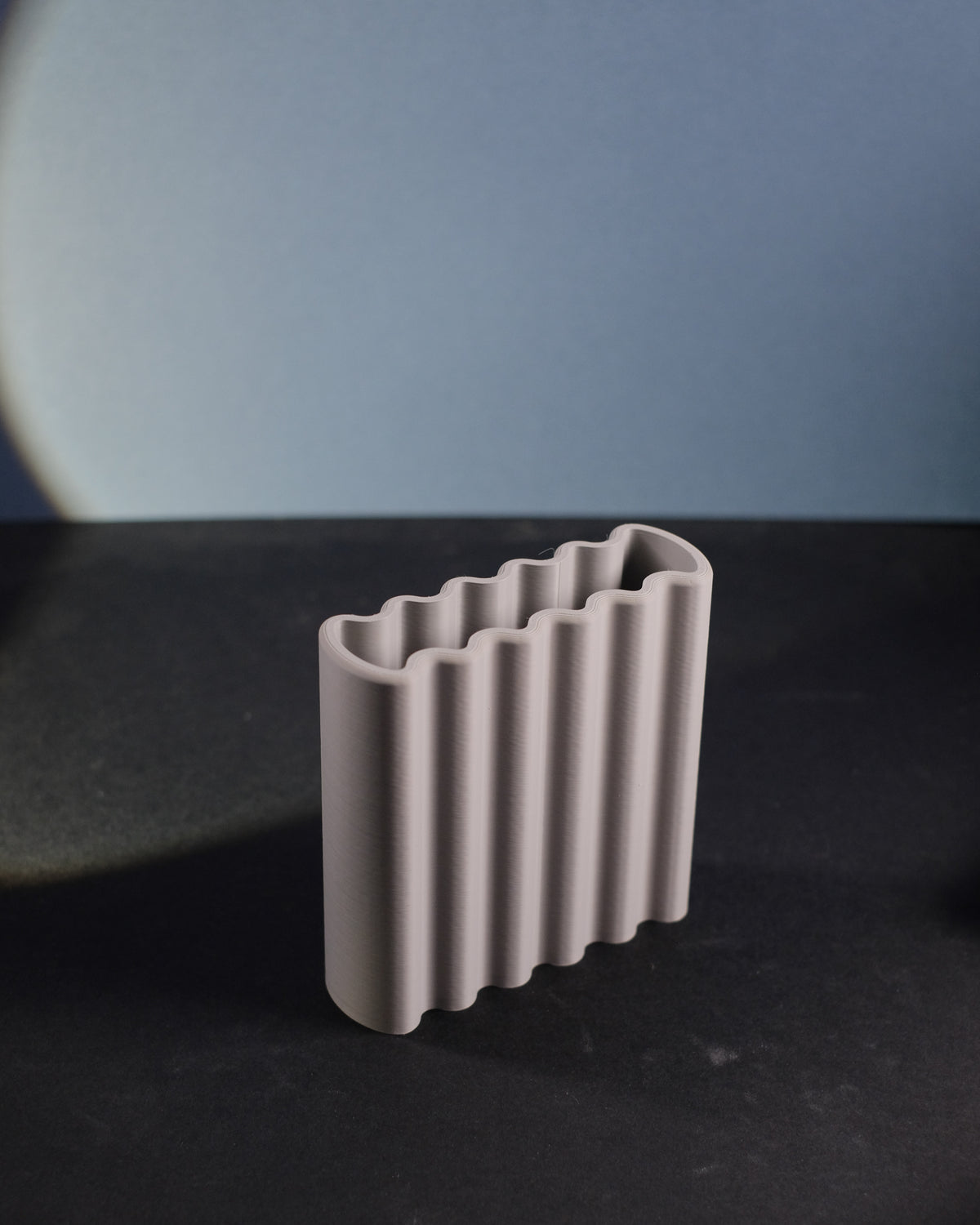 Terracotta orange ripple toothbrush holder on oak shelf close up lifestyle