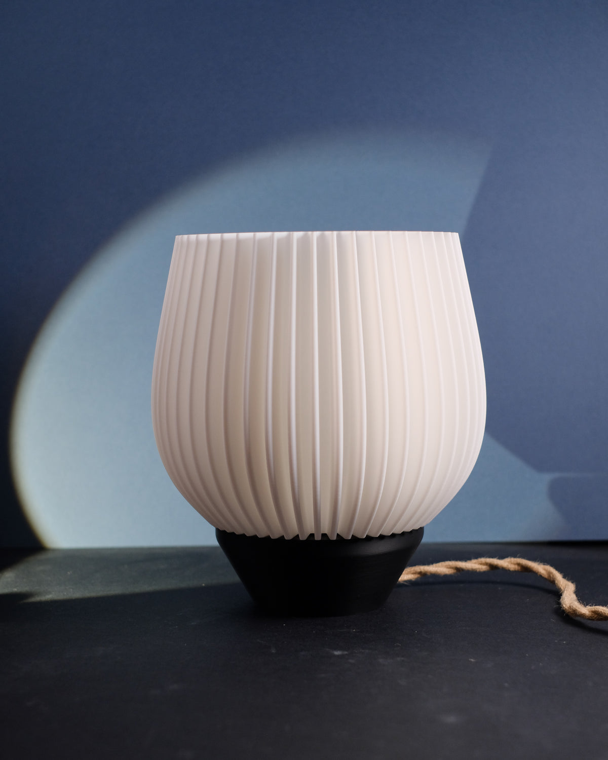 Tapered Ribbed E27 Lamp - white shade with black base on blue background
